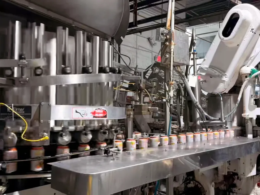 Cans moving through the filler and seamer on the line in Doral