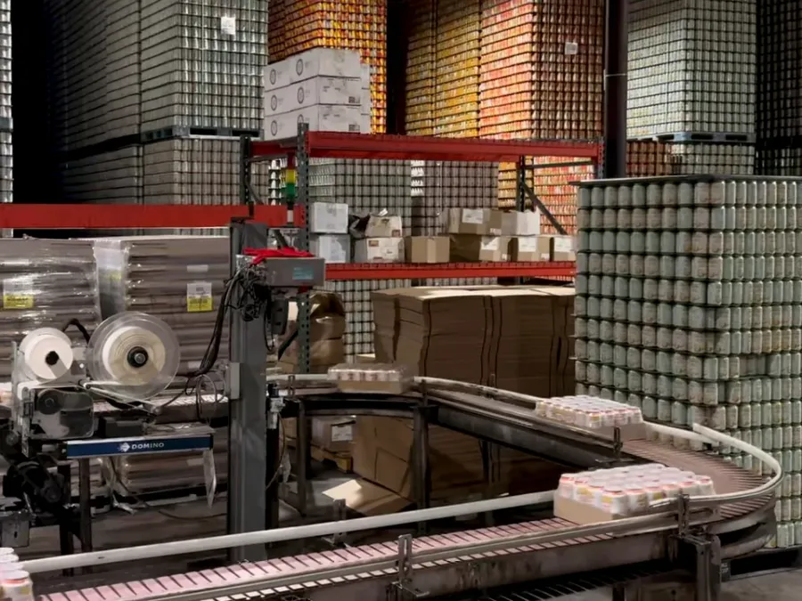 Pallets of finished cans stacked in the warehouse